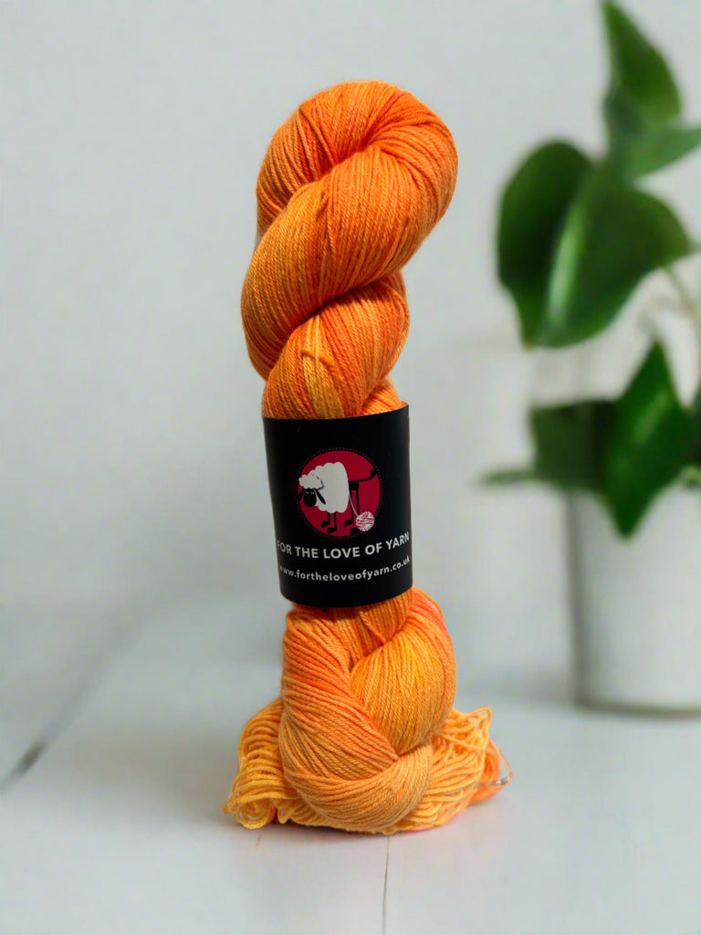 A skein of merino and nylon yarn in orange