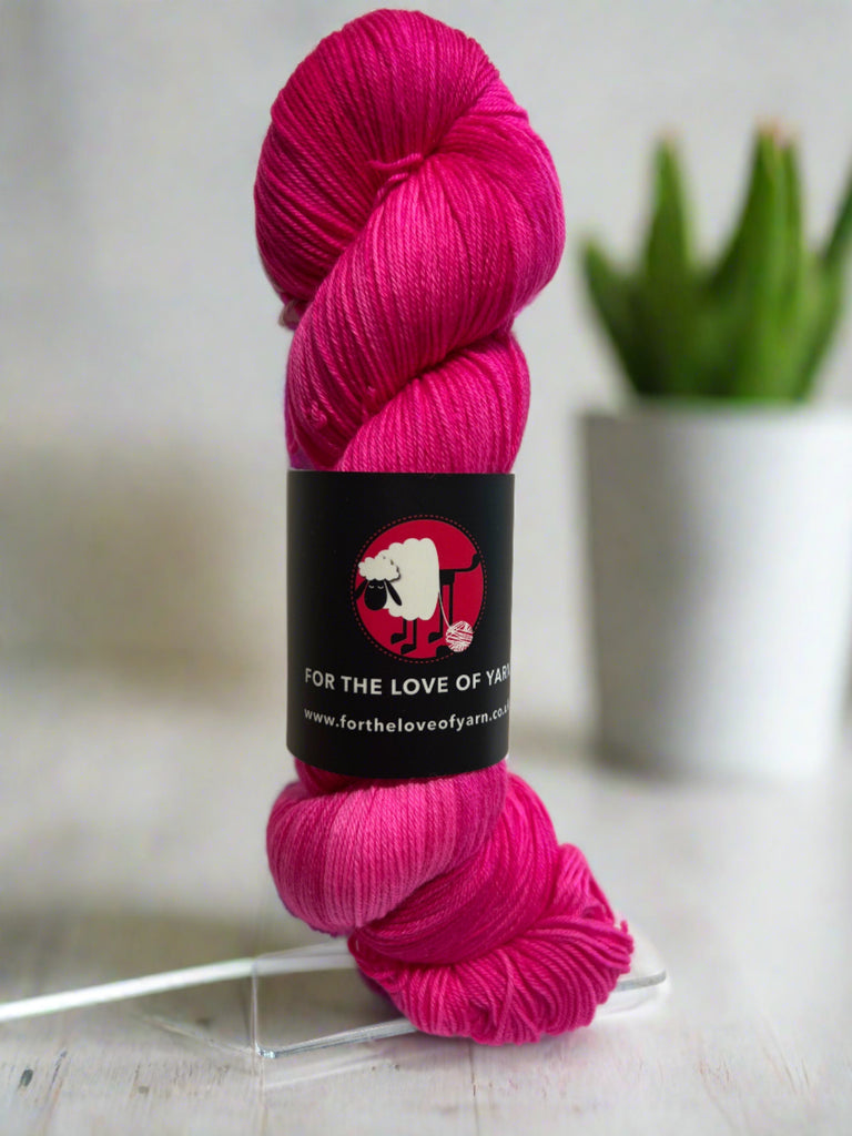 A skein of Pow Pink merino and nylon yarn