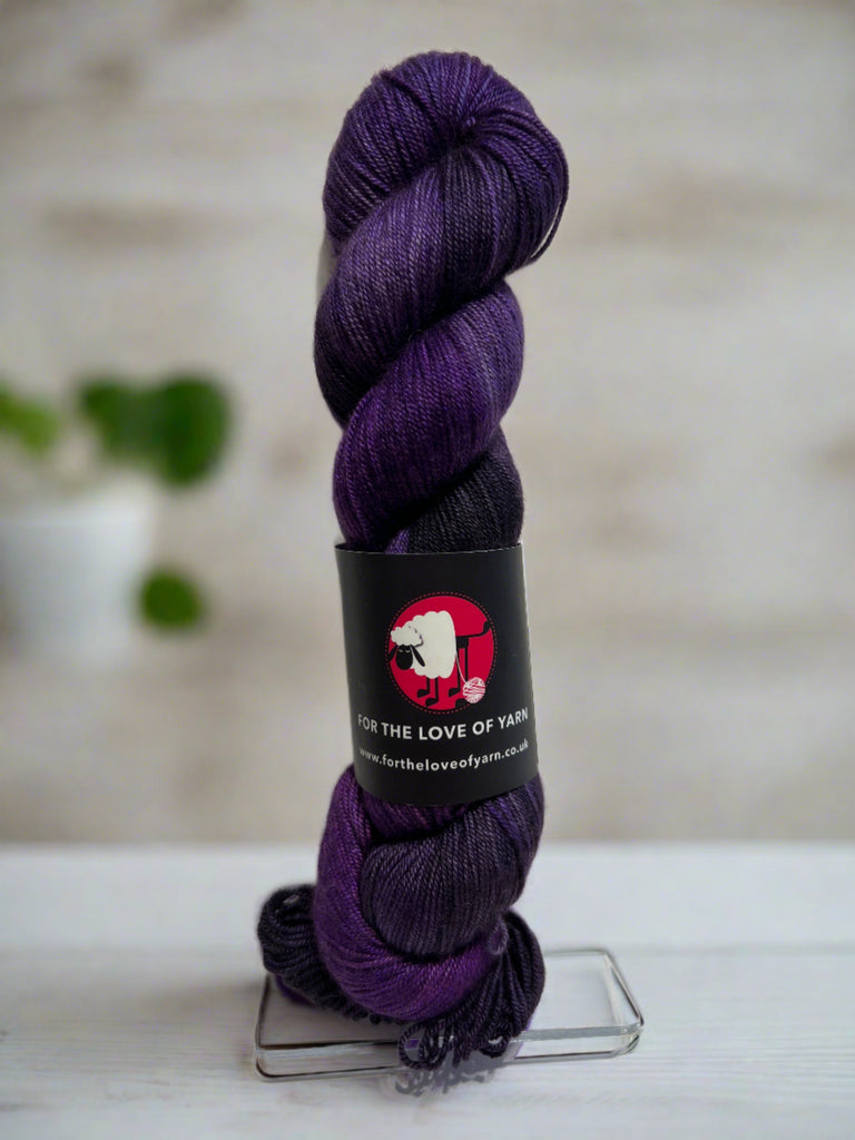 A skein of Big Man merino, silk and yak yarn in purple