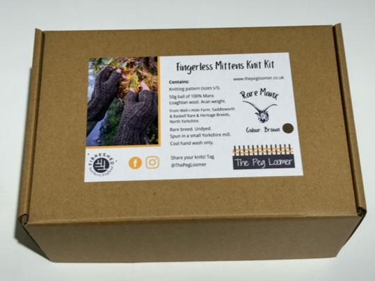 image is of a knitting kit in a brown box with an image on the front of a hand in fingerless mittens