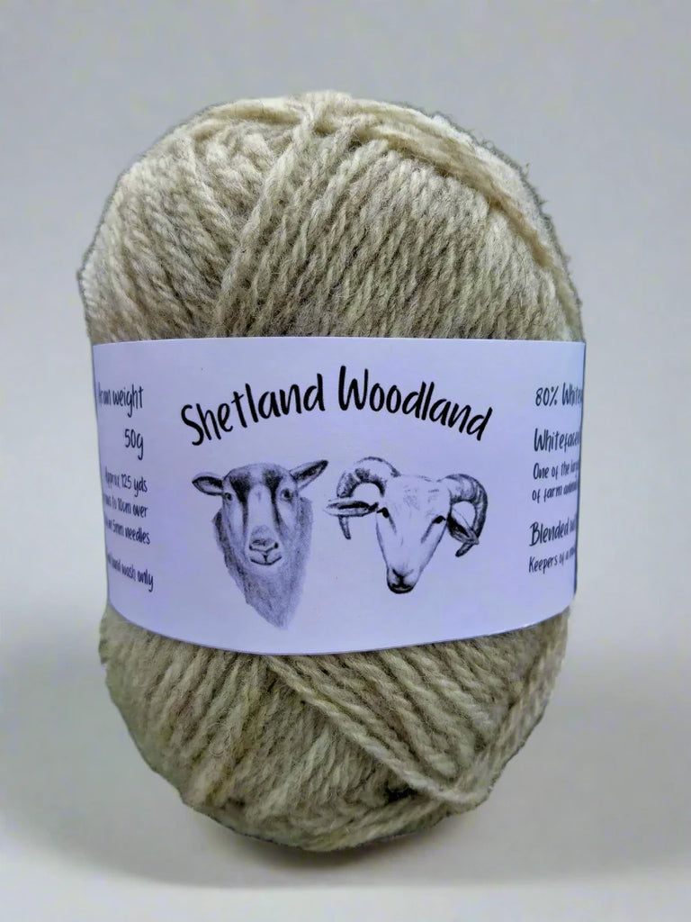 image shows a 50g ball of shetland woodland rare breed yarn in a natural grey colour